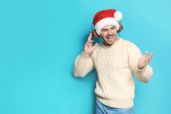 Ung Man Santa Hatt Lyssnar Julmusik Färg Bakgrunden — Stockfoto
