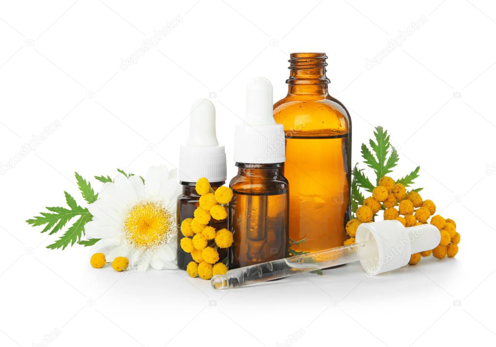 Composition with essential oils and flowers on white background