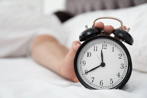 Man Turning Alarm Clock Bedroom Stock Photo