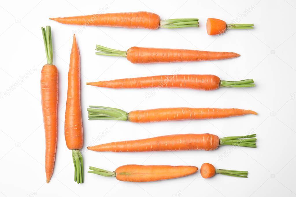 Ripe fresh carrots on white background