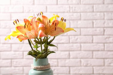 Tuğla duvar yakınındaki güzel çiçek açan lily çiçekler