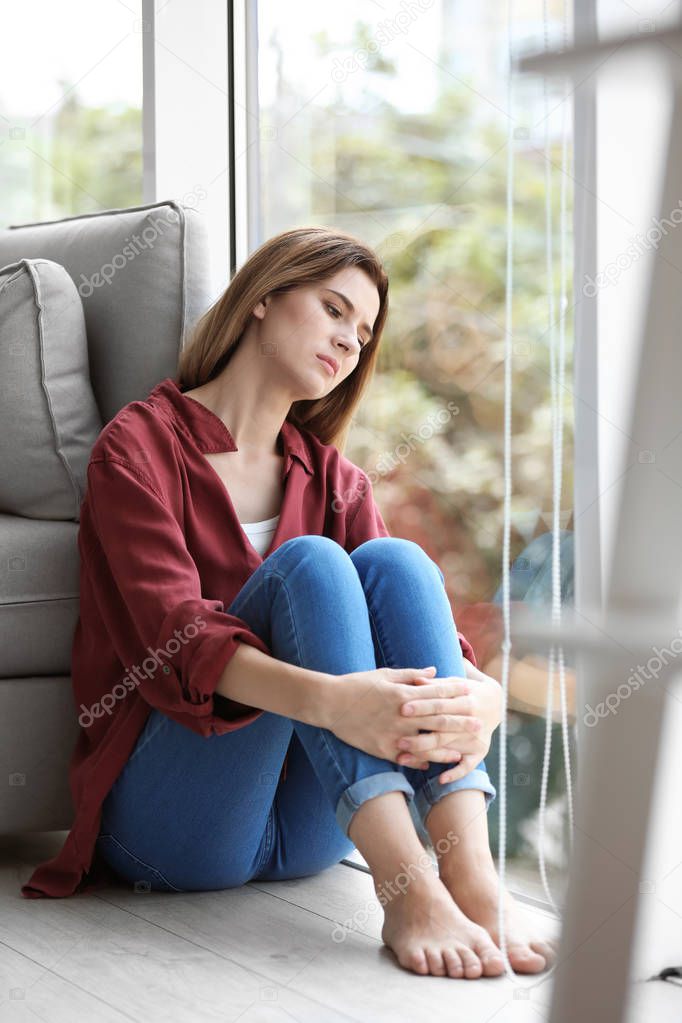 Lonely woman suffering from depression at home