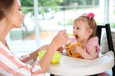 Şefkatli anne onun şirin bebek evde sağlıklı gıda ile besleme