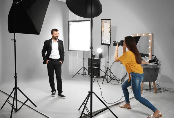 Professional team working with model in photo studio