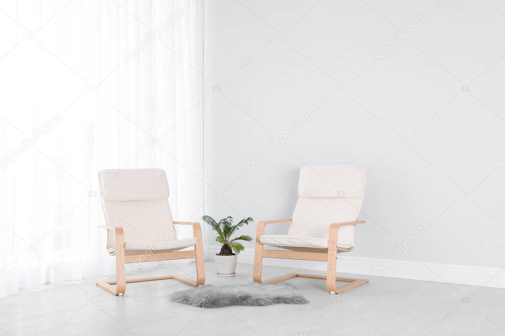 Elegant room interior with stylish comfortable armchairs