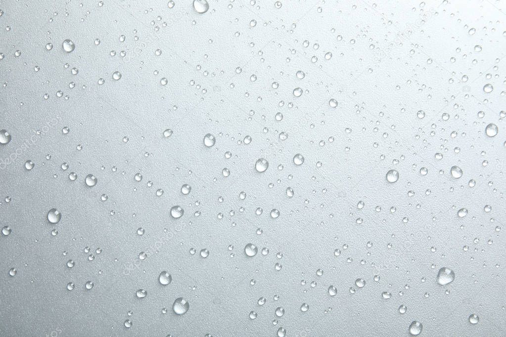 Many clean water drops on grey background