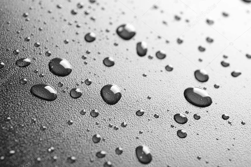 Many clean water drops on black background