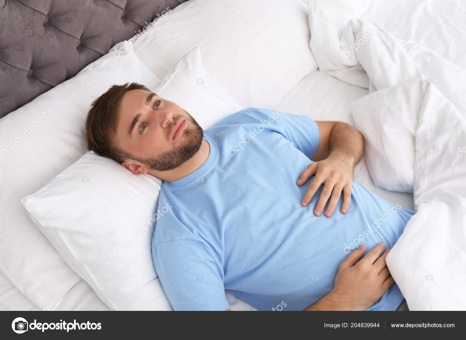 Young Man Lying Bed Home Sleep Disorder Stock Photo by ©NewAfrica 204839944