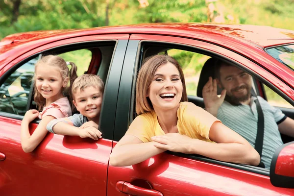 Happy family with children taking road trip together