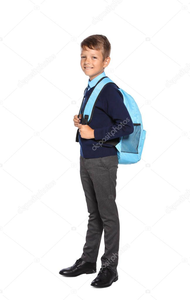 Little boy in stylish school uniform on white background