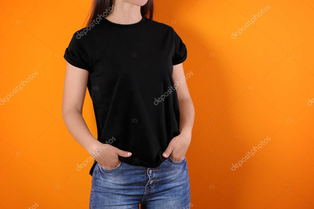 Young woman in black t-shirt on color background. Mockup for design