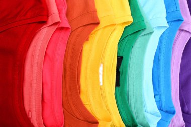 Many trendy colorful t-shirts, close up view clipart