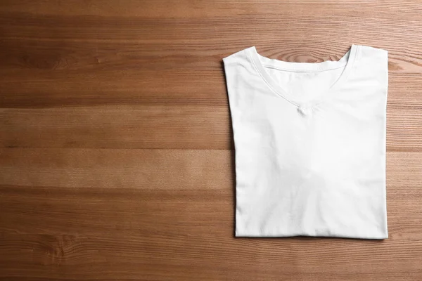 Blank t-shirt on wooden background