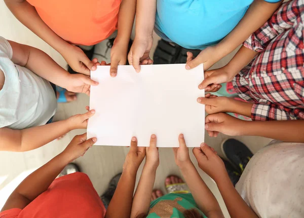 Little Children Holding Sheet Paper Hands Together Top View Unity — Stock Photo, Image