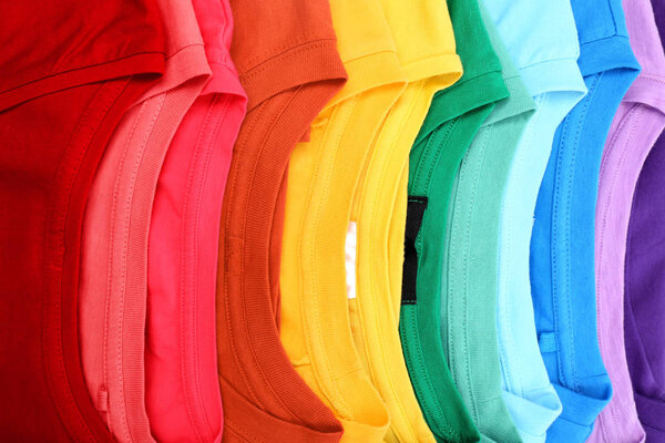 Many trendy colorful t-shirts, close up view