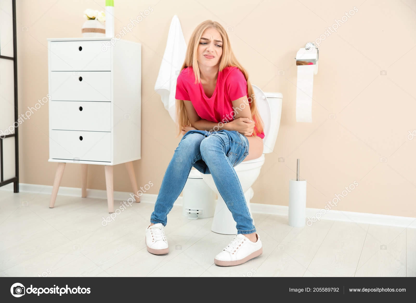 Redhead girl sitting on the toilet Redhead girl sitting on the toilet
