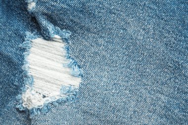 Arka plan olarak yırtık kot pantolon doku