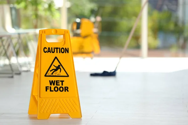 Safety Sign Phrase Caution Wet Floor Blurred Mop Bucket Background — Stock Photo, Image
