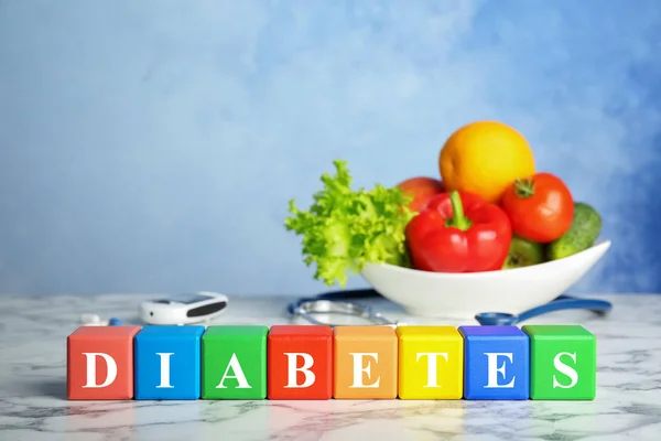 Color blocks and healthy food on table. Diabetes concept