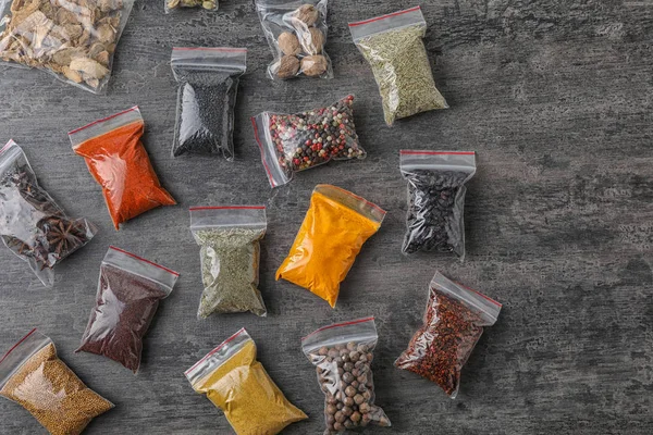 Plastic Bags Different Spices Grey Background Top View — Stock Photo, Image