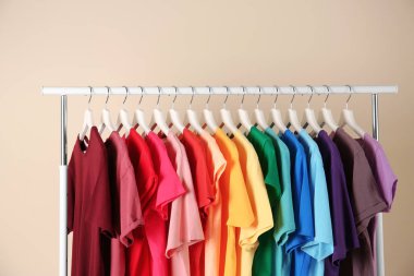 Birçok t-shirt açık renkli üzerinde gökkuşağı renk düzeni asılı