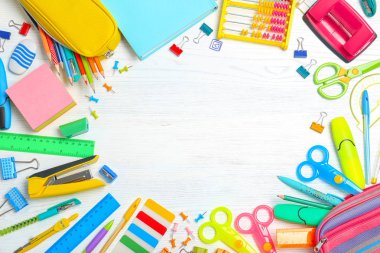 Flat lay composition with different school stationery on wooden background clipart