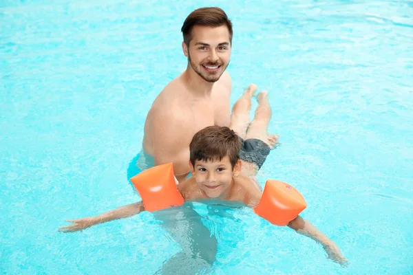 Padre Insegnare Figlio Nuotare Con Maniche Gonfiabili Piscina — Foto Stock