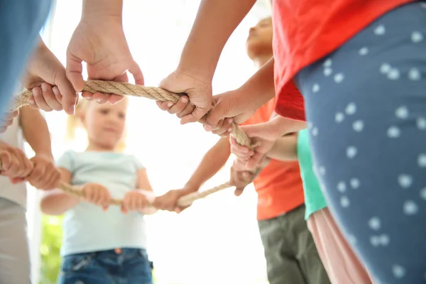 Little Children Holding Rope Light Background Focus Hands Unity Concept — Stock Photo, Image