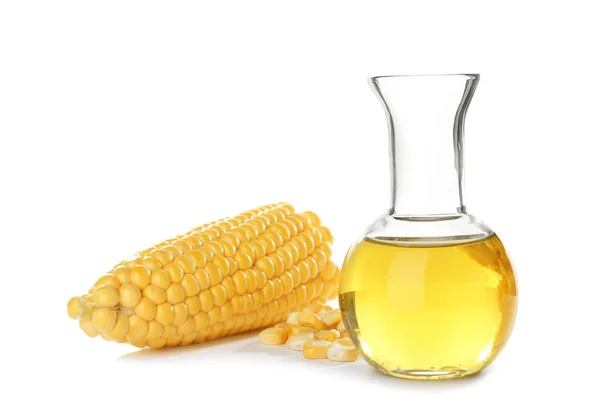 Jug with fresh corn oil and fresh cob on white background