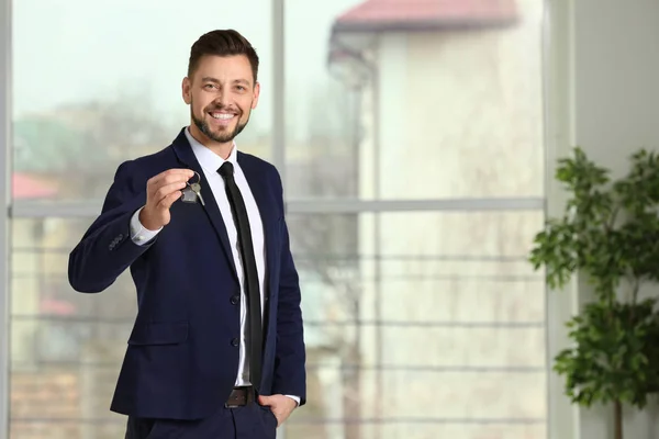 Real Estate Agent Holding House Key Indoors — Stock Photo, Image