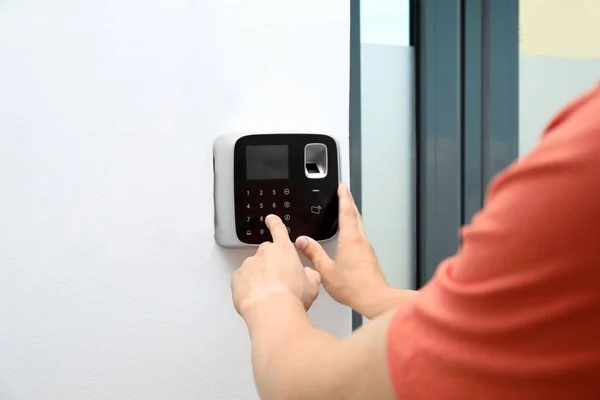Young Man Entering Code Alarm System Keypad Indoors — Stock Photo, Image