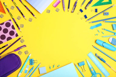 Flat lay composition with different school stationery on color background clipart