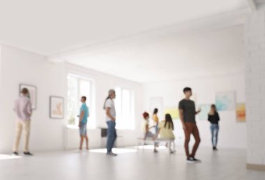 Blurred view of people at exhibition in art gallery clipart