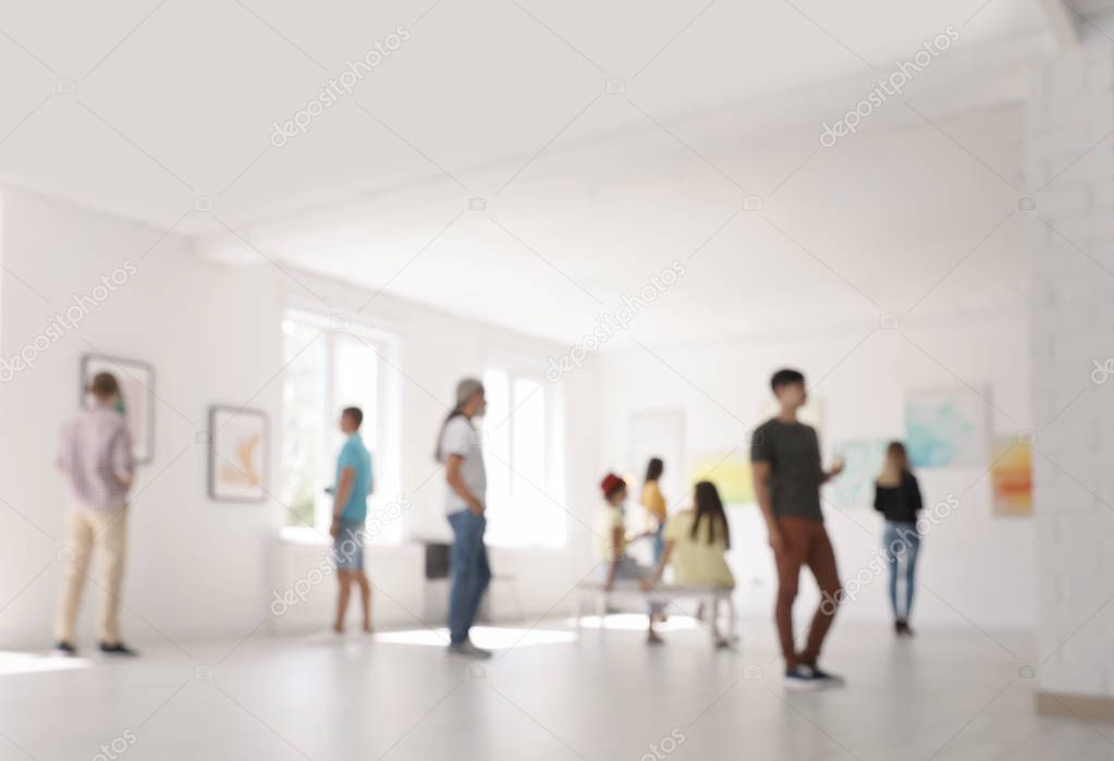 Blurred view of people at exhibition in art gallery