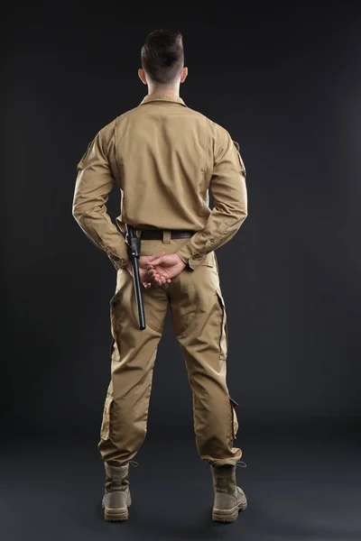Male security guard in uniform on dark background