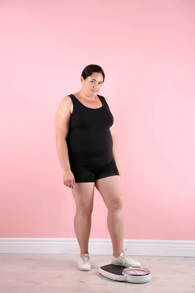 Mujer Con Sobrepeso Ropa Deportiva Usando Escamas Cerca Pared Color —  Fotos de Stock