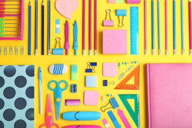 Flat lay composition with different school stationery on color background clipart