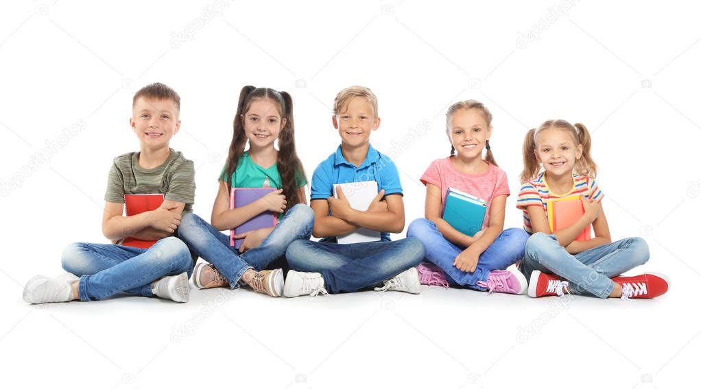 Group of little children with school supplies on white background