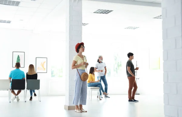 Group of people at exhibition in art gallery