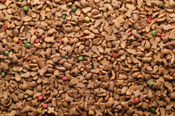 Dry pet food as background, top view