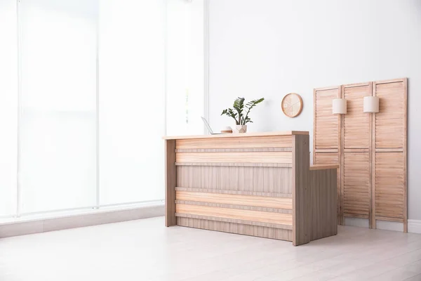 Hotel lobby interior with wooden reception desk