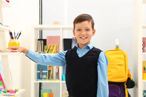 Cute child choosing school stationery in store