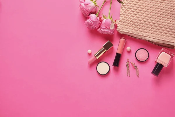 Flat lay composition with products for decorative makeup on pink background