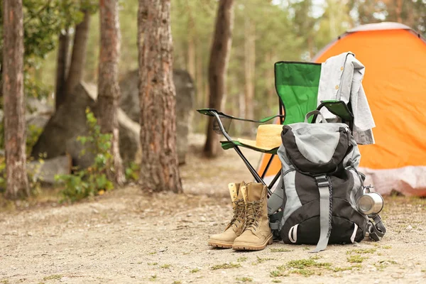 Set of camping equipment outdoors on summer day