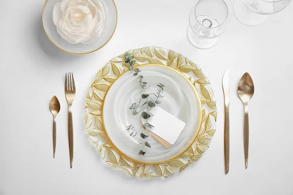 Elegant table setting on light background, top view