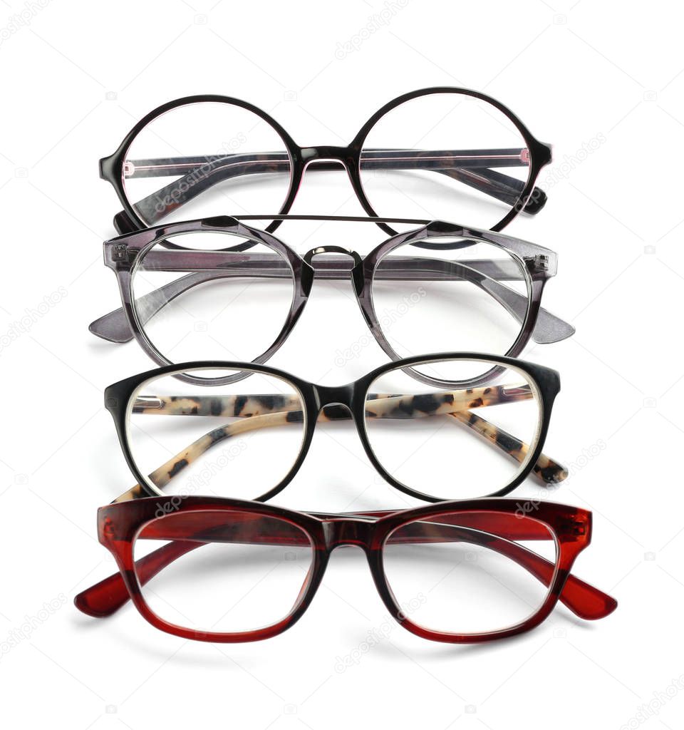 Different glasses with corrective lenses on white background. Vision problem