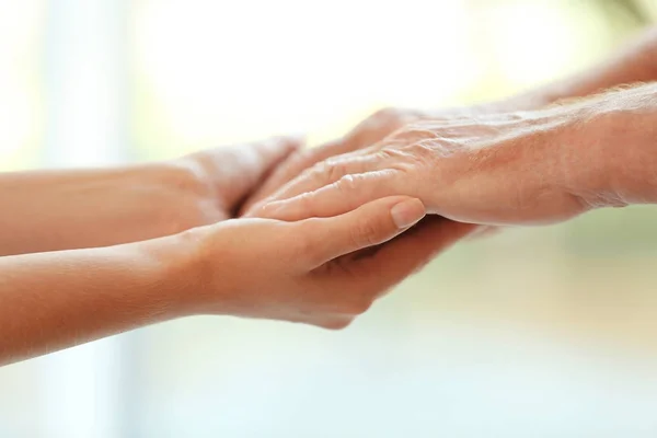 Young Woman Holding Elderly Man Hands Blurred Background Closeup Help — Stock Photo, Image