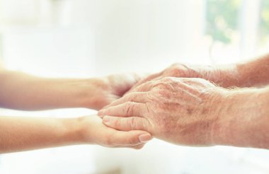 Bulanık arka planda ellere yardım etmek, yakın çekim. Yaşlılara bakım kavramı