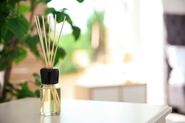 Aromatic reed air freshener on table indoors