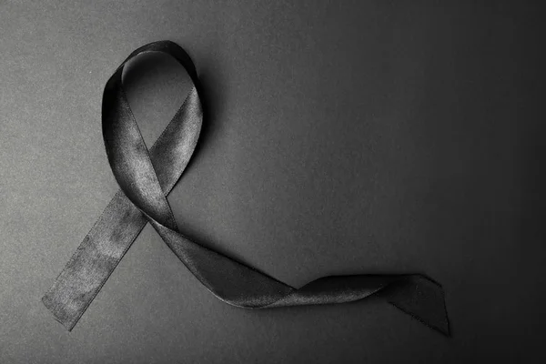 Black ribbon on dark background, top view with space for text. Funeral  symbol Stock Photo by ©NewAfrica 303049460